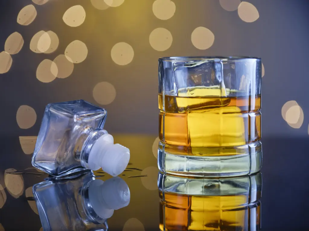 glass of whiskey with ice and a bottle 2026 03 26 23 24 33 utc (1)