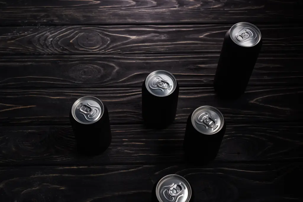 black cans on a dark wood surface 2026 01 06 00 26 07 utc
